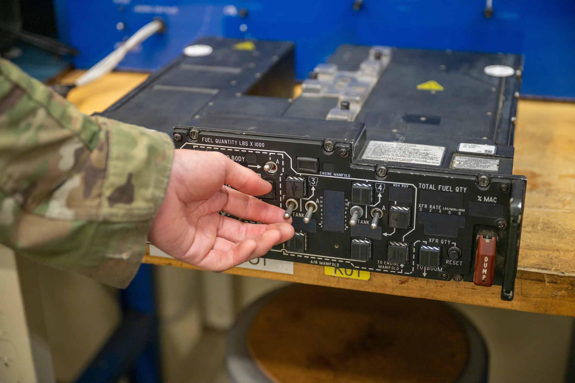 A man toggles a switch for repair.