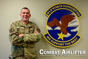 A man in uniform poses for a photo.
