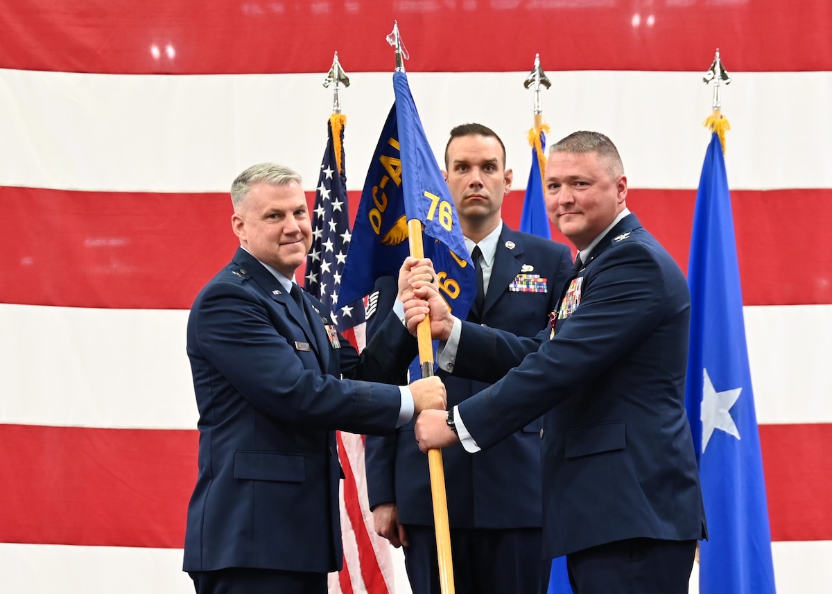 Two men holding flag.