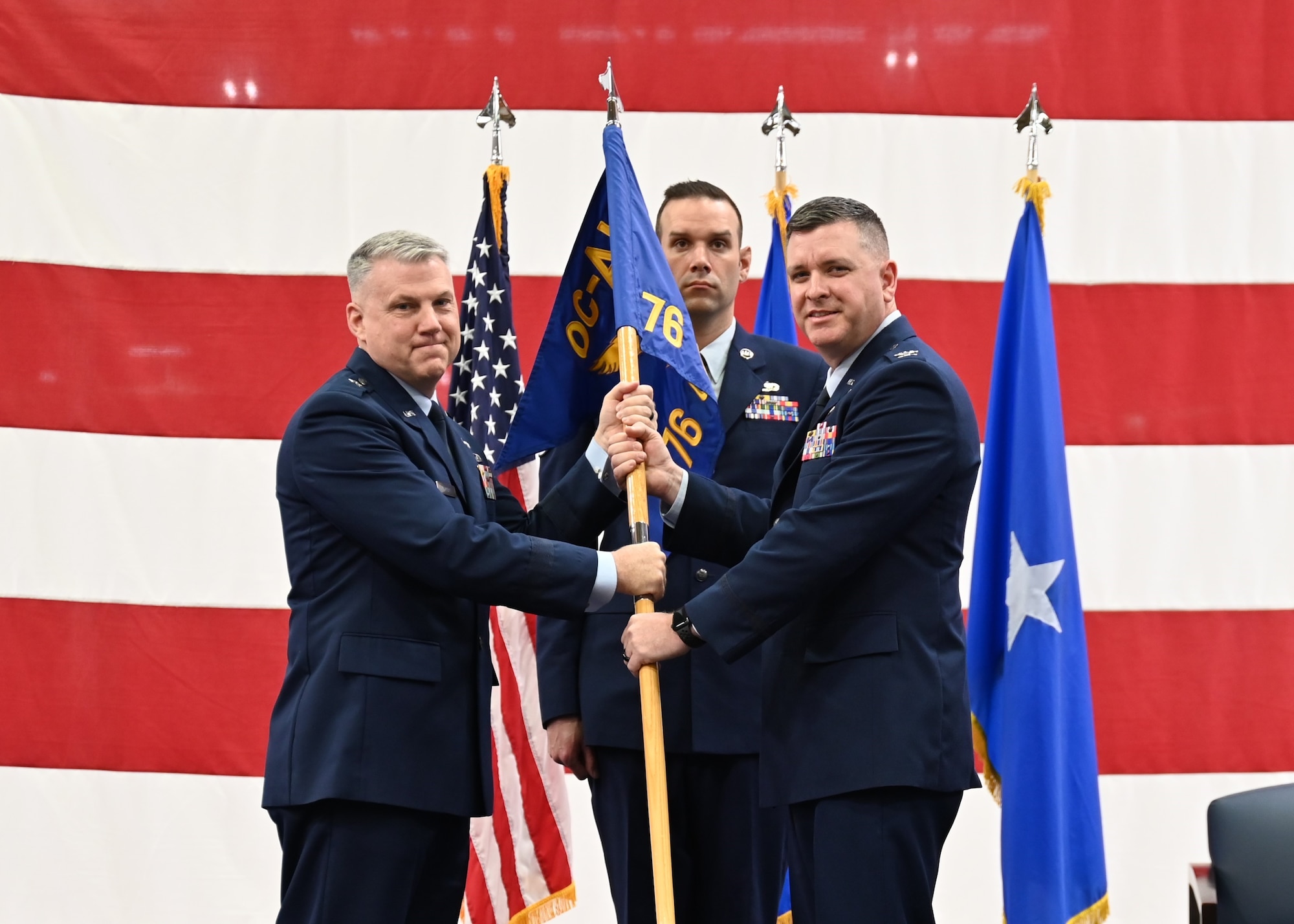 Two men holding flag.
