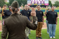 Col. Whitney Jensen, U.S. Army 3rd Recruiting Brigade commander, administers the Oath of Enlistment to 18 Future Soldiers before an Indianapolis Indians baseball game at Victory Field in Indianapolis June 14, 2025. The Indians paid special tribute to the Army's 250th birthday. (U.S. Army photo by Mark R. W. Orders-Woempner)