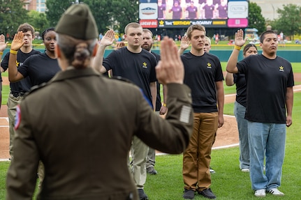 Col. Whitney Jensen, U.S. Army 3rd Recruiting Brigade commander, administers the Oath of Enlistment to 18 Future Soldiers before an Indianapolis Indians baseball game at Victory Field in Indianapolis June 14, 2025. The Indians paid special tribute to the Army's 250th birthday. (U.S. Army photo by Mark R. W. Orders-Woempner)