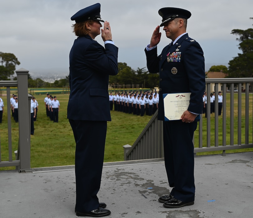 U.S. Air Force Col. Angelina Maguinness, 17th Training Wing commander, presents the Legion of Merit award to the 517th Training Group outgoing commander, Col. Mark Jones, during the 517th TRG change of command ceremony on Soldier Field at the Presidio of Monterey, California, June 12, 2025. Jones served as the assistant commandant and the 517th TRG commander, directing language training for 34,000 Department of Defense personnel annually in more than 24 languages at 29 sites worldwide. (U.S. Air Force photo by Staff Sergeant Nathan Call)