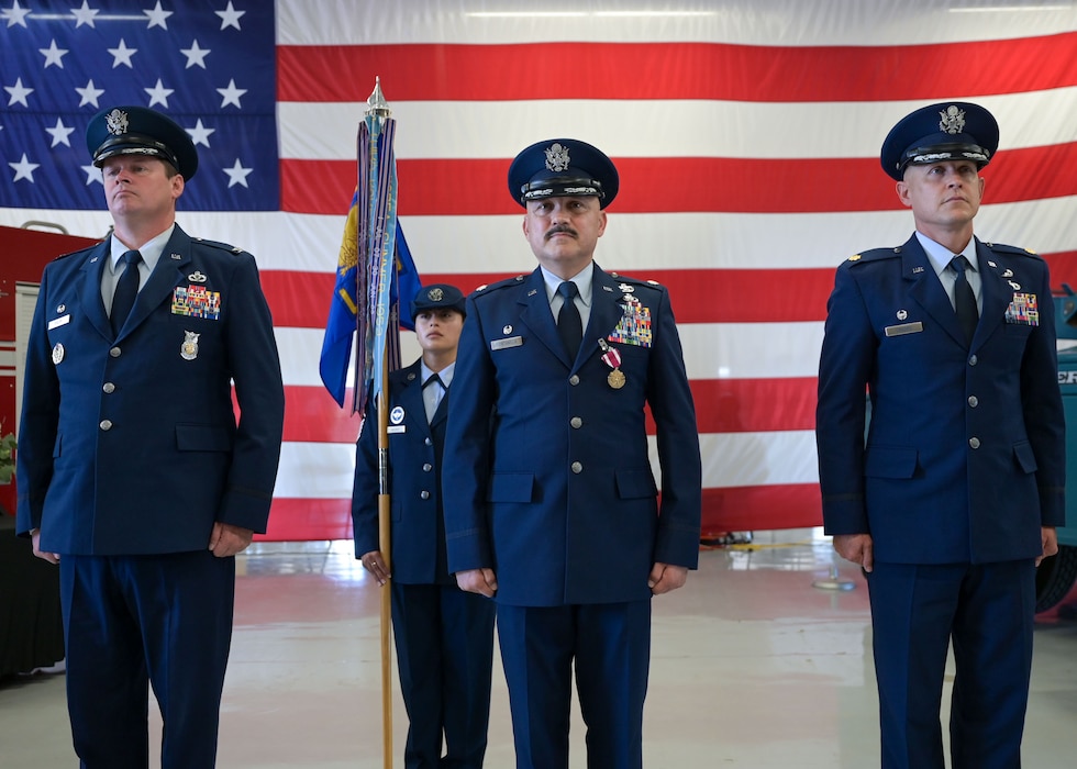 U.S. Air Force Col. Timothy Dalby, 17th Mission Support Group commander, left, Lt. Col. Jose Quintanilla, 17th Logistics Readiness Squadron outgoing commander, middle, and Maj. Charles D. Crooks, 17th LRS incoming commander, right, stand at attention during the 17th LRS change of command ceremony at Goodfellow Air Force Base, Texas, June 13, 2025. The passing of colors from an outgoing commander to an incoming commander ensures the unit and its Airmen are never without leadership, a continuation of trust. (U.S. Air Force photo by Senior Airman Evelyn J. D’Errico)