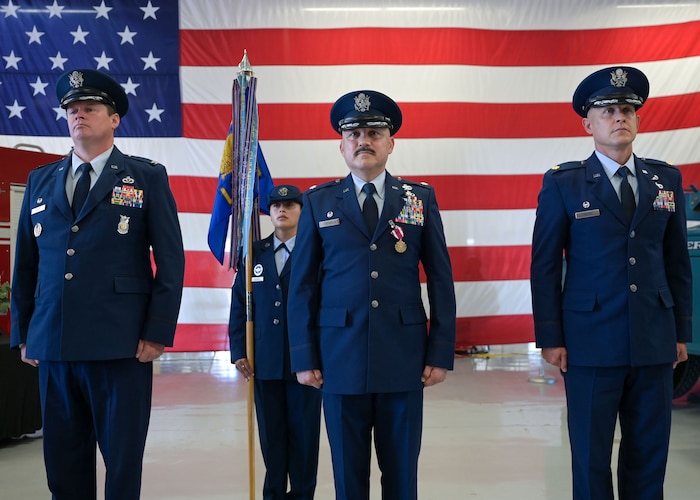 U.S. Air Force Col. Timothy Dalby, 17th Mission Support Group commander, left, Lt. Col. Jose Quintanilla, 17th Logistics Readiness Squadron outgoing commander, middle, and Maj. Charles D. Crooks, 17th LRS incoming commander, right, stand at attention during the 17th LRS change of command ceremony at Goodfellow Air Force Base, Texas, June 13, 2025. The passing of colors from an outgoing commander to an incoming commander ensures the unit and its Airmen are never without leadership, a continuation of trust. (U.S. Air Force photo by Senior Airman Evelyn J. D’Errico)