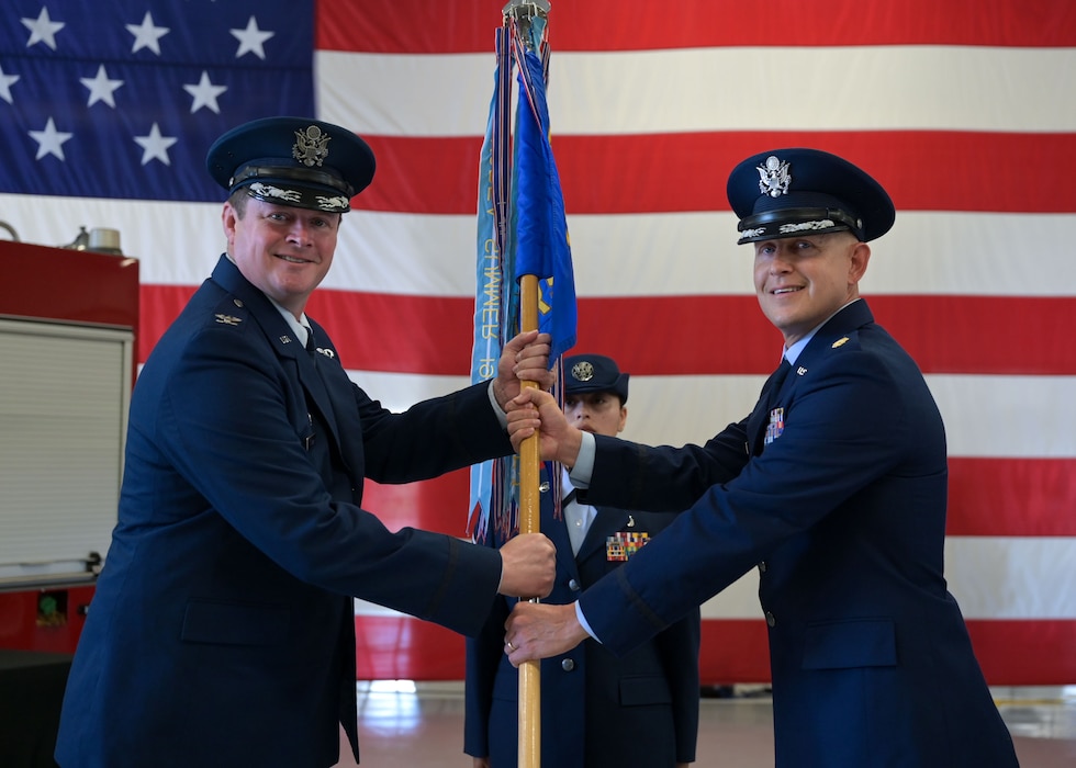 U.S. Air Force Maj. Charles D. Crooks, 17th Logistics Readiness Squadron incoming commander, receives the 17th LRS guidon from Col. Timothy Dalby, 17th Mission Support Group commander, during the 17th LRS change of command ceremony at Goodfellow Air Force Base, Texas, June 13, 2025. Changes of command are a military tradition representing the transfer of responsibilities from the presiding official to the upcoming official. (U.S. Air Force photo by Senior Airman Evelyn J. D’Errico)