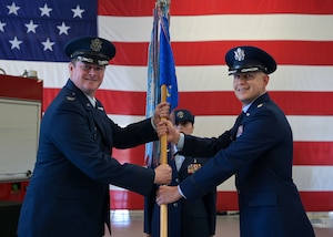 U.S. Air Force Maj. Charles D. Crooks, 17th Logistics Readiness Squadron incoming commander, receives the 17th LRS guidon from Col. Timothy Dalby, 17th Mission Support Group commander, during the 17th LRS change of command ceremony at Goodfellow Air Force Base, Texas, June 13, 2025. Changes of command are a military tradition representing the transfer of responsibilities from the presiding official to the upcoming official. (U.S. Air Force photo by Senior Airman Evelyn J. D’Errico)
