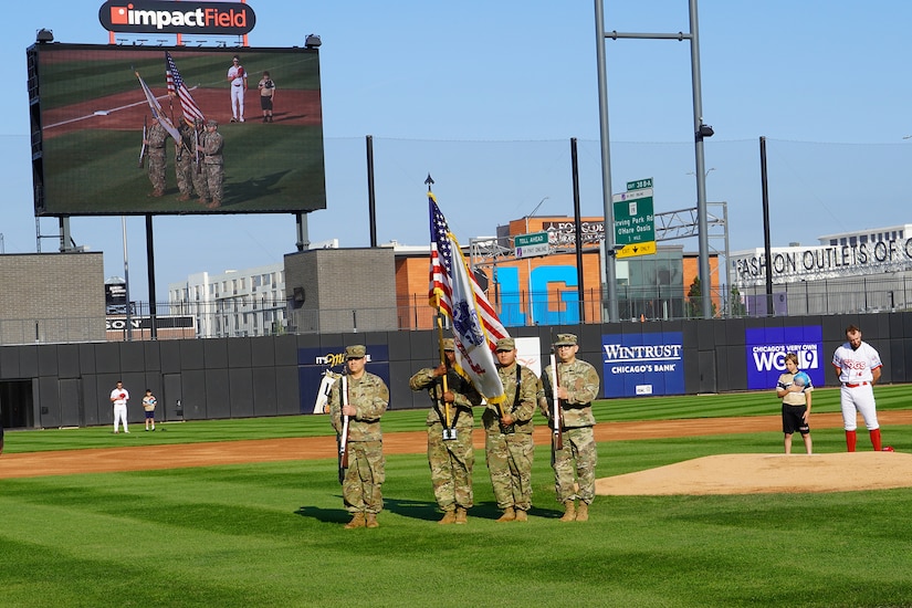 Soldiers assigned to the 85th U.S. Army Reserve Command color guard team presents the colors during the National Anthem before the start of the Chicago Dogs versus the Cleburne Railroaders baseball game at Impact Field in Rosemont, Illinois, June 14, 2025.