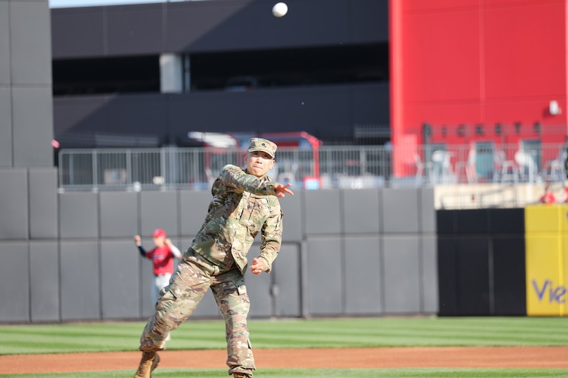 Lt. Col. Christopher Tung, G-3/Assistant Chief of Staff, 85th U.S. Army Reserve Support Command, throws out the first peach at Impact Field before the start of the Chicago Dogs versus the Cleburne Railroaders baseball game.