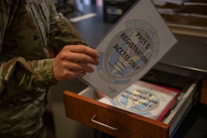 Airman gives visitor a pass.
