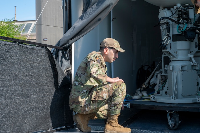 U.S. Air Force Staff Sgt. Joao Gabriel, 92nd Communications Squadron radio frequency operations noncommissioned officer in charge, inspects an antenna pedestal assembly at Fairchild Air Force Base, Washington, June 2, 2025.  The antenna pedestal assembly is a critical component of the Global Aircrew Strategic Network Terminal, which provides protected communication and supports aircrew in operational environments. (U.S. Air Force photo by Airman 1st Class Samantha Thorn)