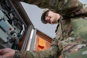 U.S. Air Force Airman 1st Class Brayden Walling, 92nd Communications Squadron radio frequency transmission technician, checks the functions on the equipment control unit at Fairchild Air Force Base, Washington, June 2, 2025.  The Global Aircrew Strategic Network Terminal system uses extremely high frequency and advanced EHF waveforms to provide protected communication capabilities in operational environments. (U.S. Air Force photo by Airman 1st Class Samantha Thorn)