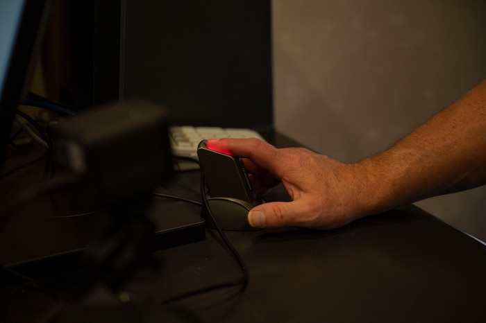 Visitor gets his fingerprint scanned.