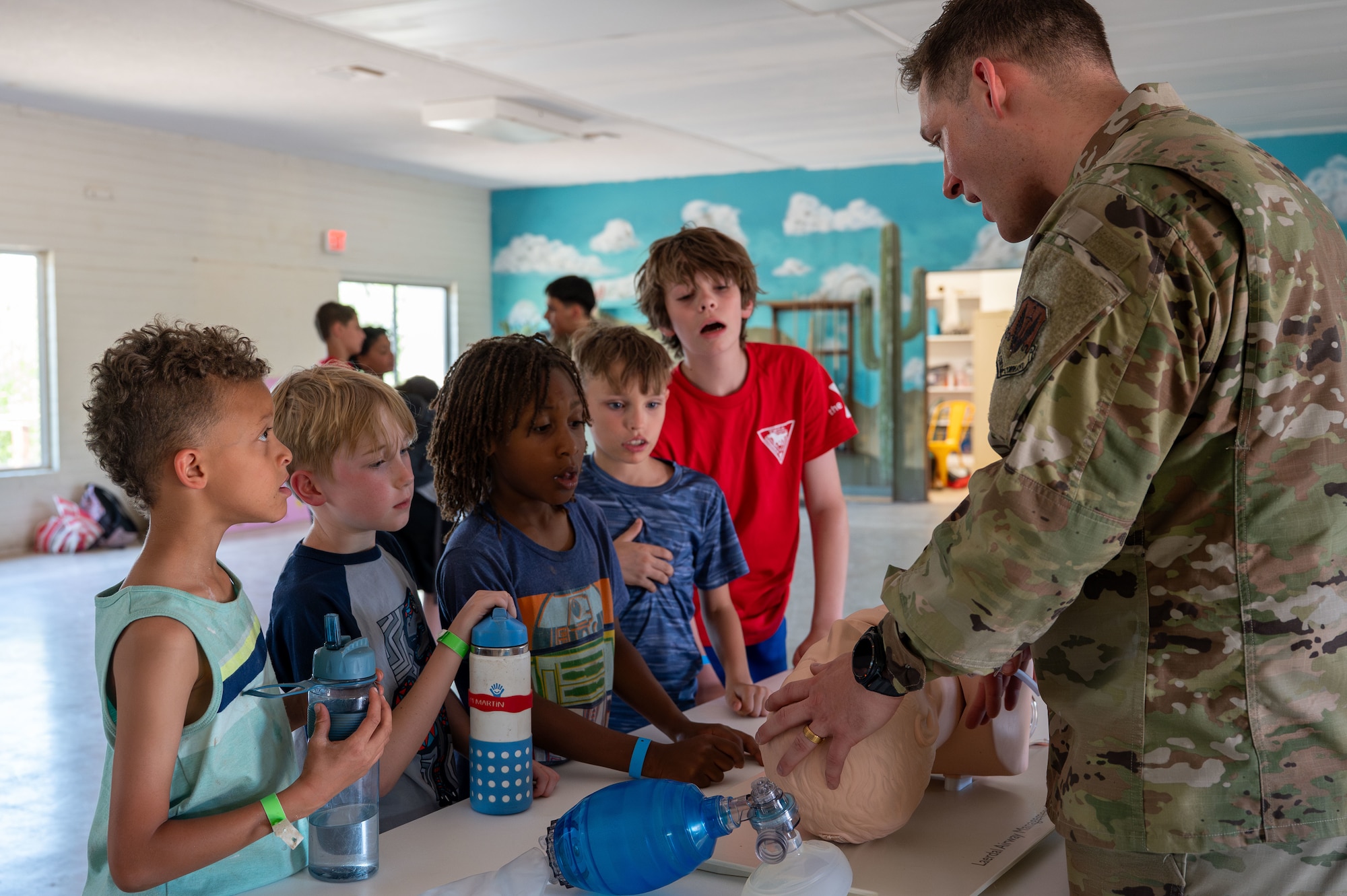 U.S. Air Force Senior Airman Logan Encinas, 355th Operational Medical Readiness Squadron dental technician, demonstrates nasal intubation on a training aid to YMCA Triangle Y Ranch campers at Oracle, Arizona, June 12, 2025. Airmen provided interactive demonstrations to give campers an understanding of Air Force operations. (U.S. Air Force photo by Senior Airman Jasmyne Bridgers-Matos)