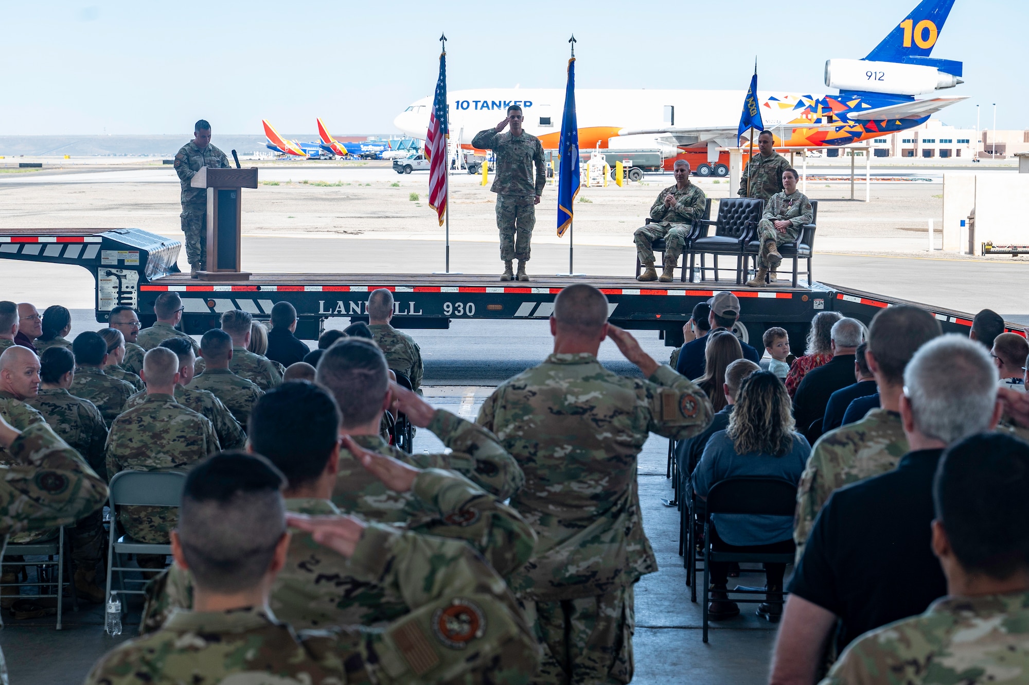 Group of people salute a man