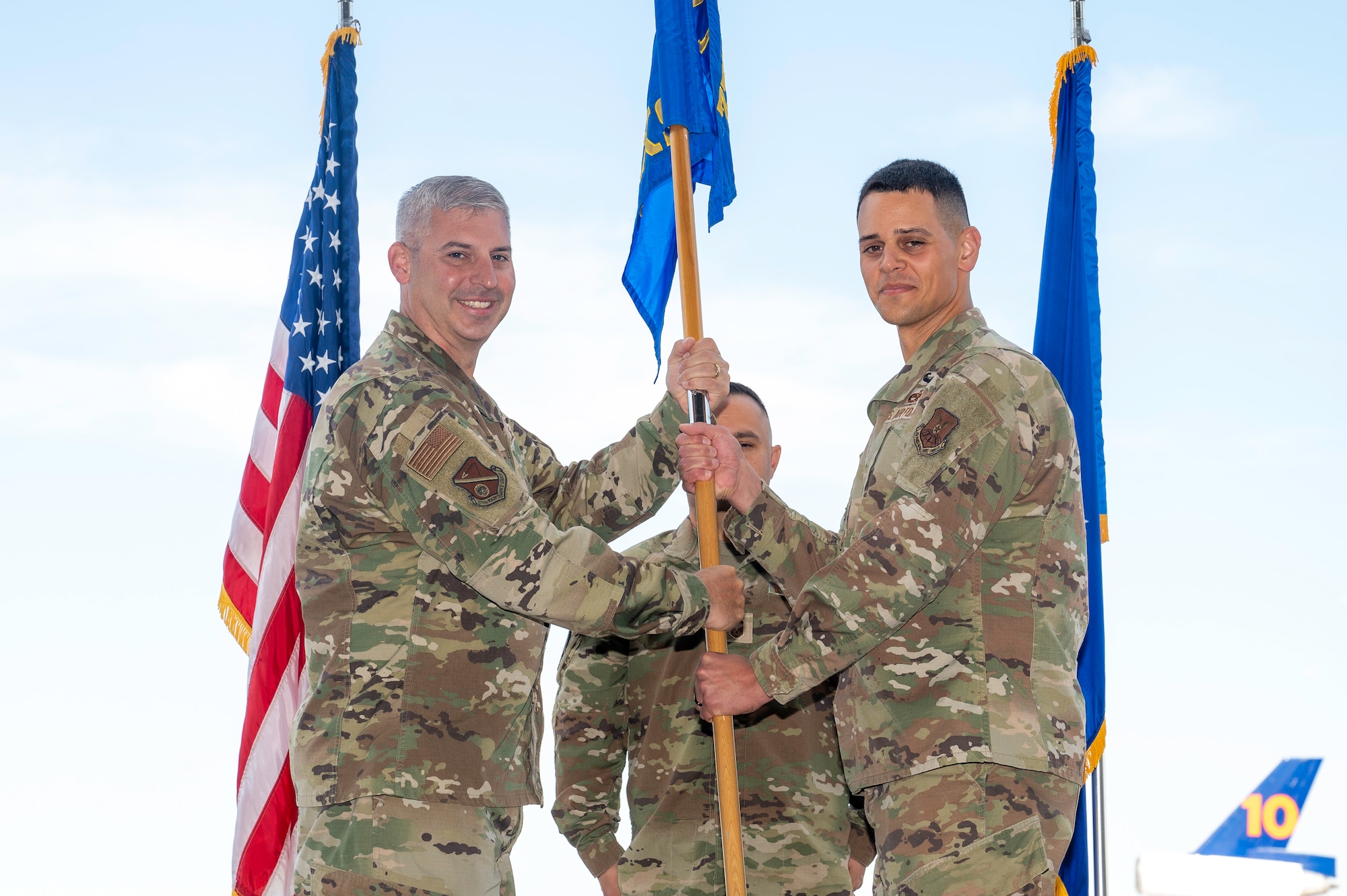 Man passes flag to another man