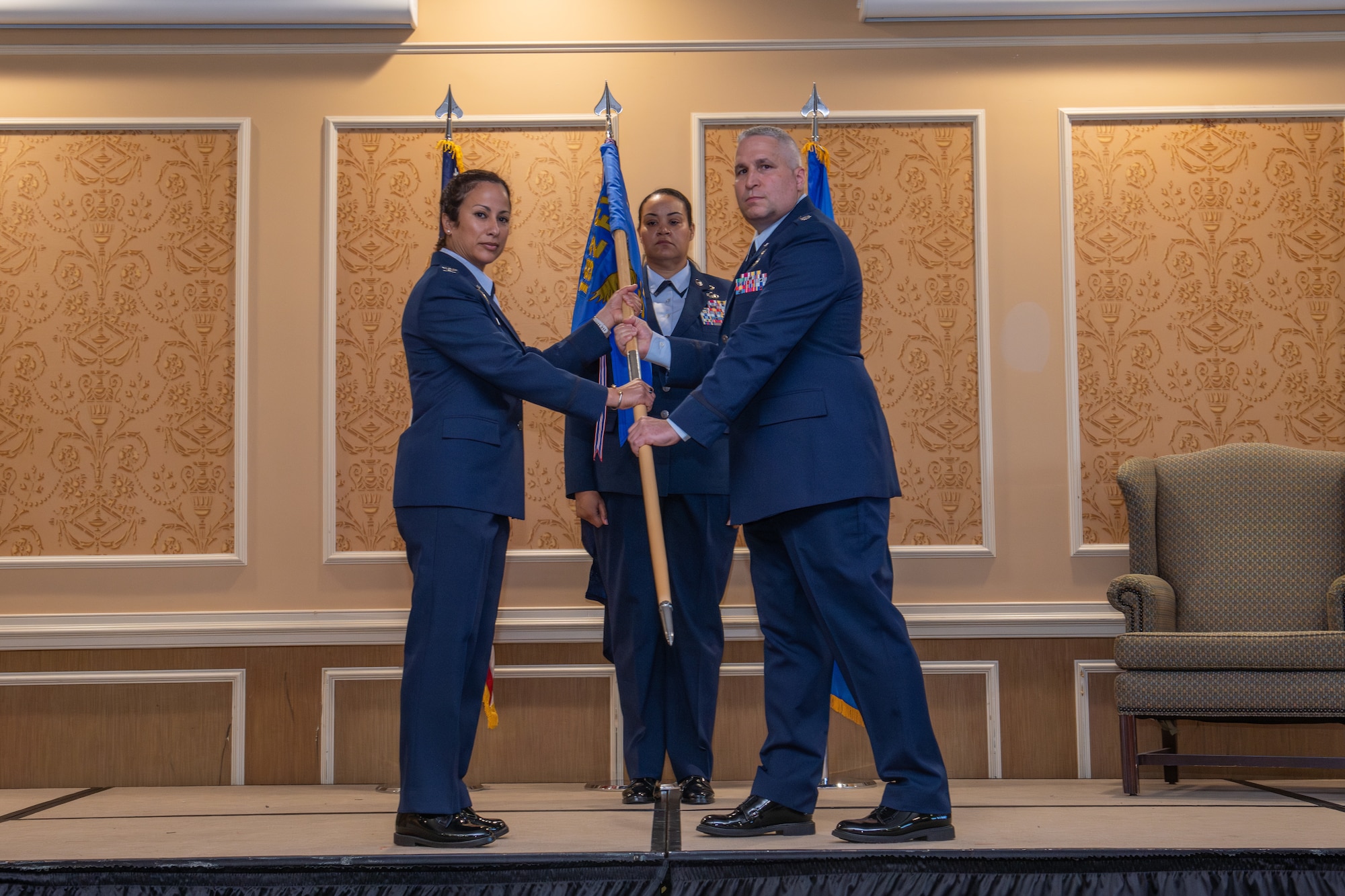 Col. Manaal I. Burge, left, 192nd Mission Support Group commander, passes the guidon to Lt. Col. Alex J. Shamp, incoming 192nd Force Support Squadron commander.