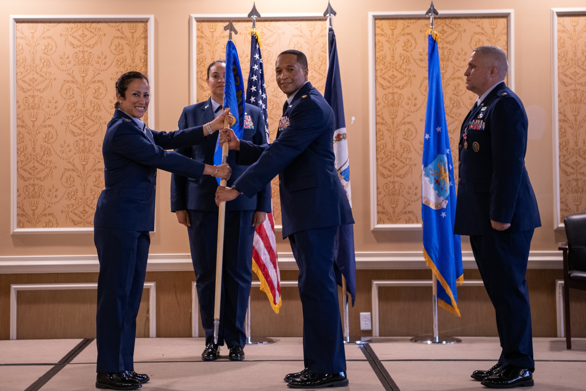Maj. Bakari S. Prioleau, center, takes the 192nd Force Support Squadron guidon from Col. Manaal I. Burge.