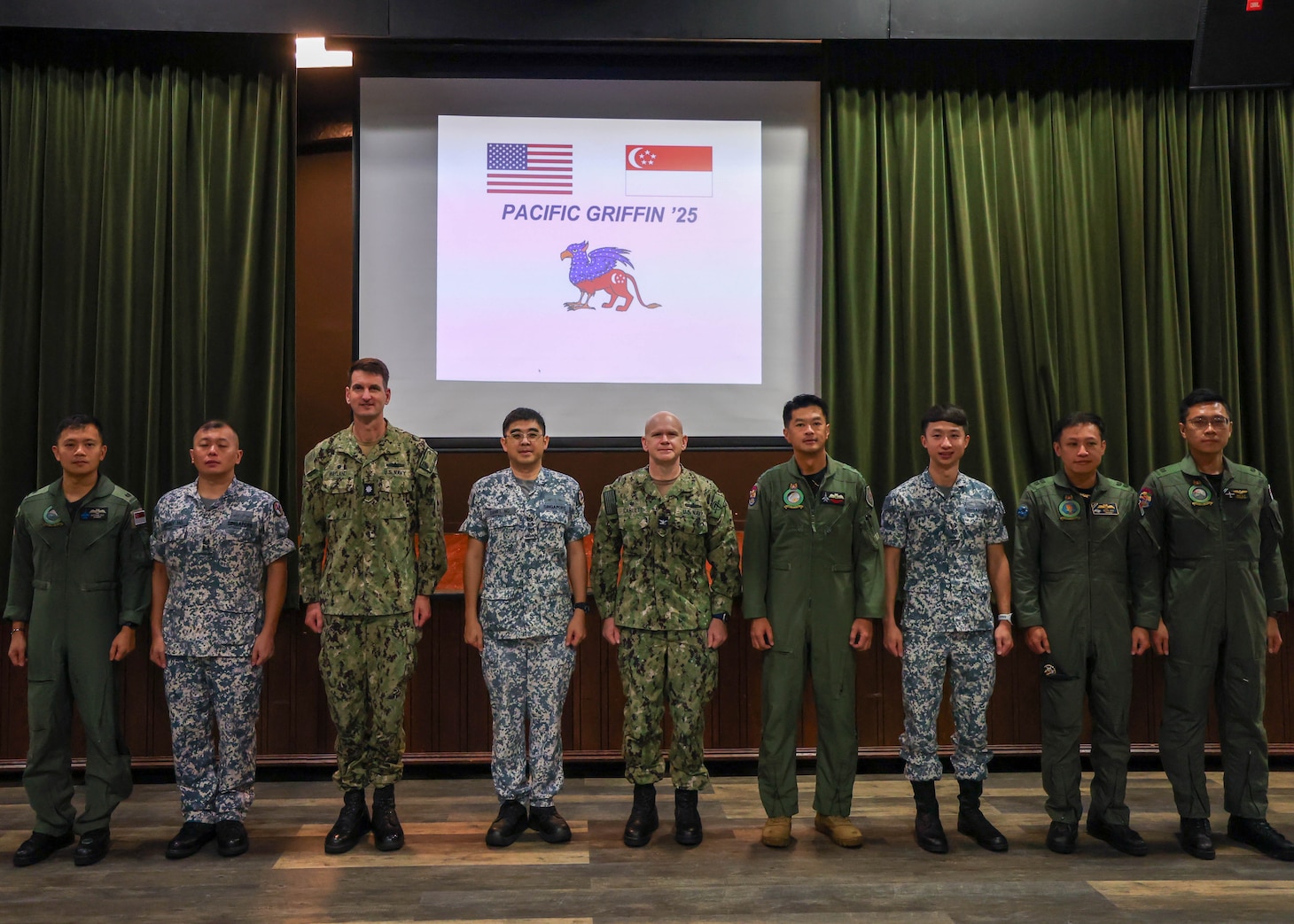 U.S. Naval Base, GUAM (June 6, 2025) – U.S. Navy Sailors from Destroyer Squadron (DESRON) Seven, the Arleigh Burke-class guided-missile destroyer USS William P. Lawrence (DDG 110), and Republic of Singapore Navy Sailors with the Independence-class littoral mission vessel RSS Sovereignty (LMV 16) and Formidable-class stealth frigate RSS Supreme (FFG 73) pose for a group picture in preparation for Pacific Griffin 2025 while in port U.S. Naval Base, Guam, June 6, 2025. Pacific Griffin 2025 is a biennial maritime exercise between the U.S. and Republic of Singapore, enhancing combined maritime proficiency while strengthening relationships during dynamic training evolutions ashore and at sea near Guam. (U.S. Navy photo by Mass Communication Specialist 3rd Class Petty Officer Gavin Arnoldhendershot)