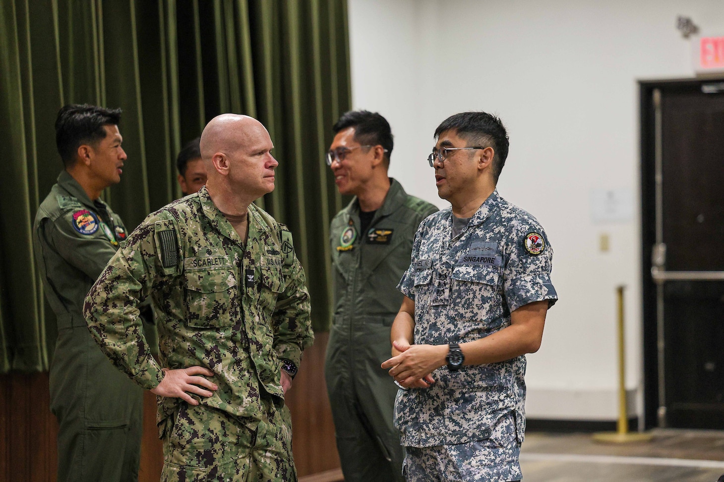 U.S. Naval Base, GUAM (June 6, 2025) – Capt. Matt Scarlett, commodore, Destroyer Squadron Seven (DESRON 7), left, and Republic of Singapore Navy Col. Daniel Ng with the 1st Flotilla, speak during a conference in preparation for Exercise Pacific Griffin 2025 while in port U.S. Naval Base, Guam, June 6, 2025. Pacific Griffin 2025 is a biennial maritime exercise between the U.S. and Republic of Singapore, enhancing combined maritime proficiency while strengthening relationships during dynamic training evolutions ashore and at sea near Guam. (U.S. Navy photo by Mass Communication Specialist 3rd Class Petty Officer Gavin Arnoldhendershot)