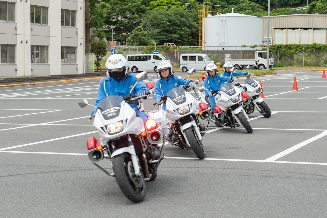 Japanese police officers show motorcycle maneuvers during a motorcycle safety demonstration at the Yokosuka Navy Exchange (NEX) parking lot onboard Commander, Fleet Activities Yokosuka (CFAY).