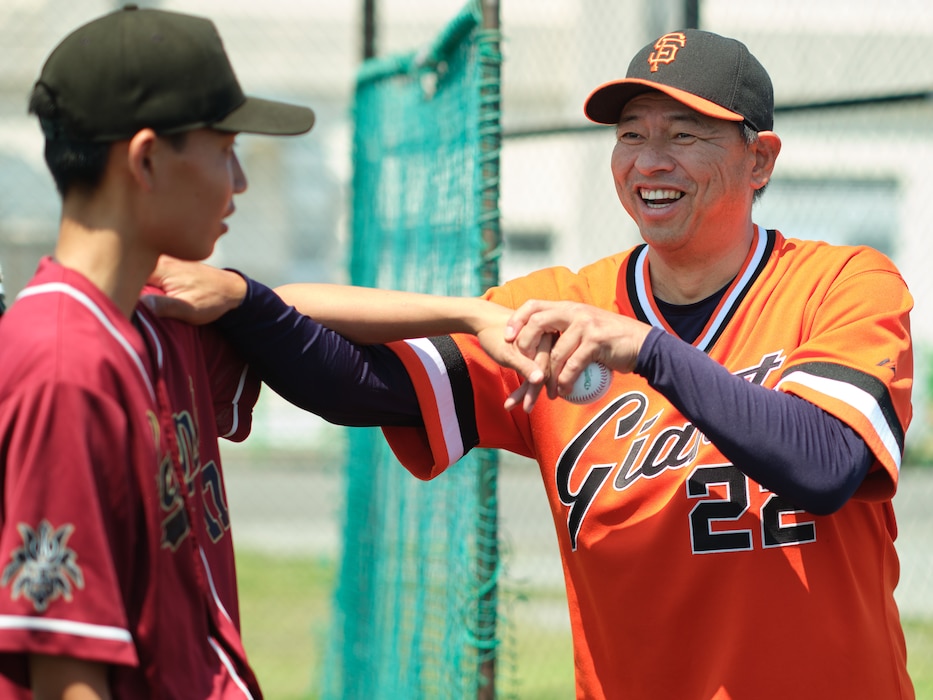 Former Major League Baseball (MLB) and Nippon Professional Baseball (NPB) star pitcher Keiichi Yabu coaches Aira Fujinuma, a  pitcher from Marine Corps Air Station Iwakuni's M.C. Perry High School, at the 10th Annual Far East All-Stars and Pro Scouting Combine June 1, 2025 at Commander, Fleet Activities Yokosuka's (CFAY) Berkey Field.