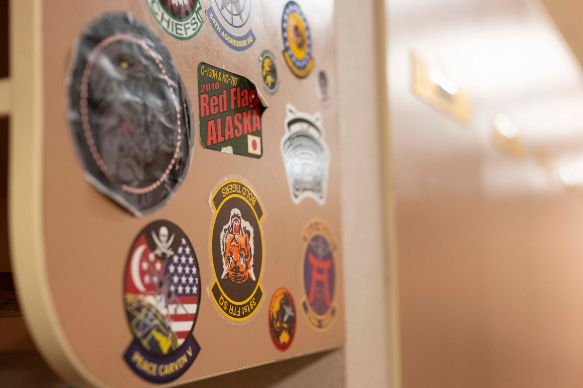 Stickers from units around the world who have supported Cope Thunder and Red Flag over the past 50 years lay on the walls of the Aircrew Flight Equipment office at the 353rd Combat Training Squadron on Eielson Air Force Base, Alaska, June 16, 2025.
