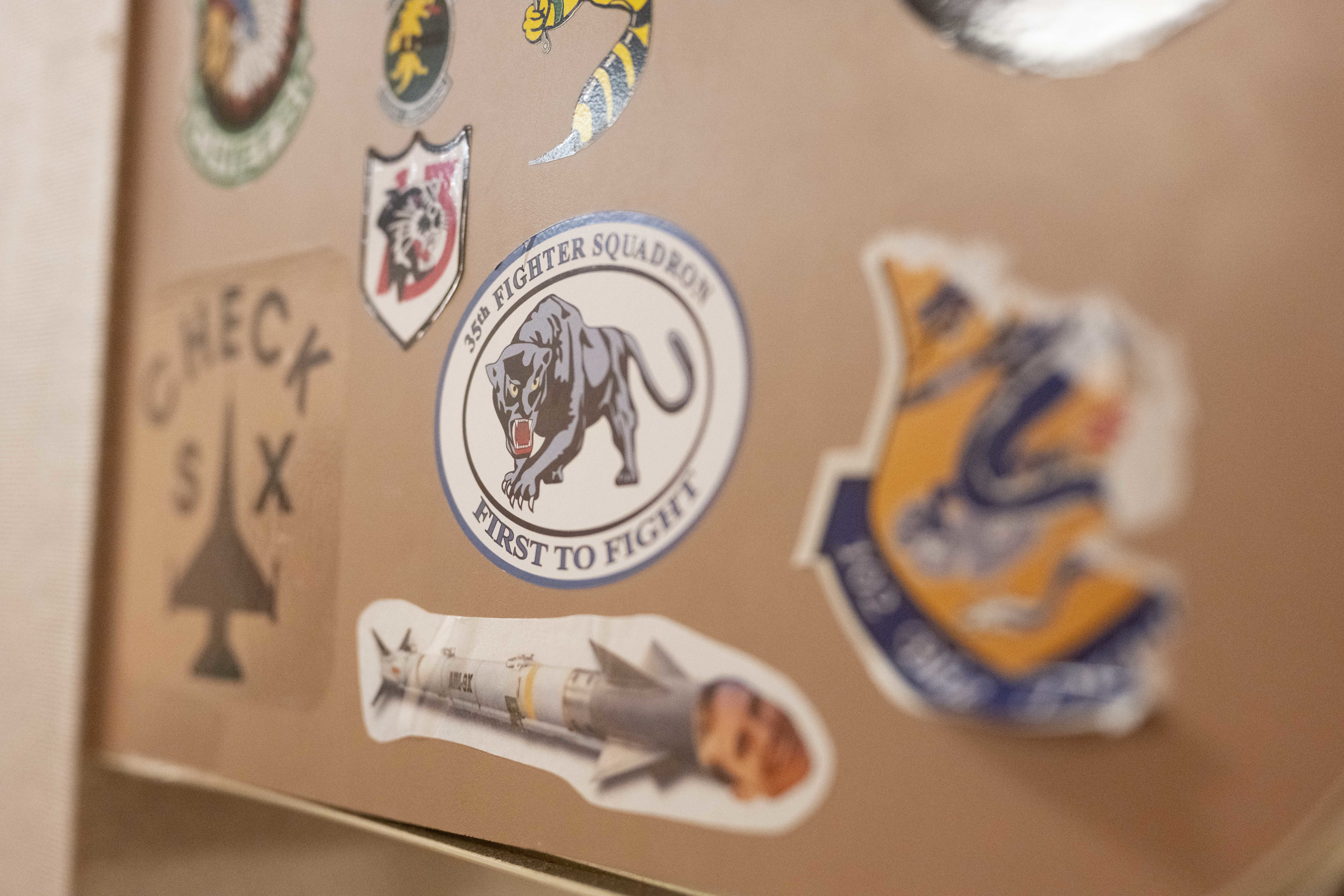 Stickers from units around the world who have supported Cope Thunder and Red Flag over the past 50 years lay on the walls of the Aircrew Flight Equipment office at the 353rd Combat Training Squadron on Eielson Air Force Base, Alaska, June 16, 2025. From Cope Thunder to Red Flag-Alaska, these units have shaped one of the longest-running joint training efforts in the Indo-Pacific. (U.S. Air Force photo by Staff Sgt. Daniel Brosam)