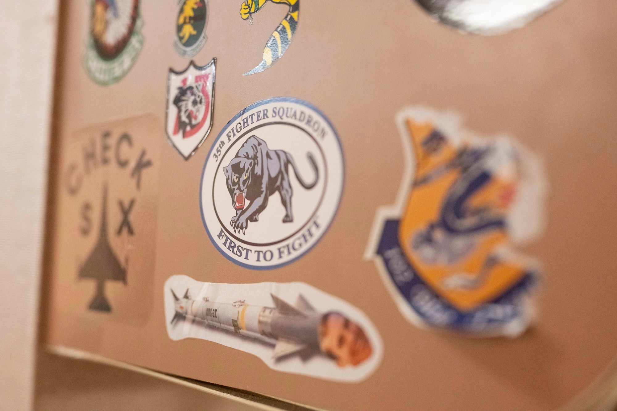 Stickers from units around the world who have supported Cope Thunder and Red Flag over the past 50 years lay on the walls of the Aircrew Flight Equipment office at the 353rd Combat Training Squadron on Eielson Air Force Base, Alaska, June 16, 2025.