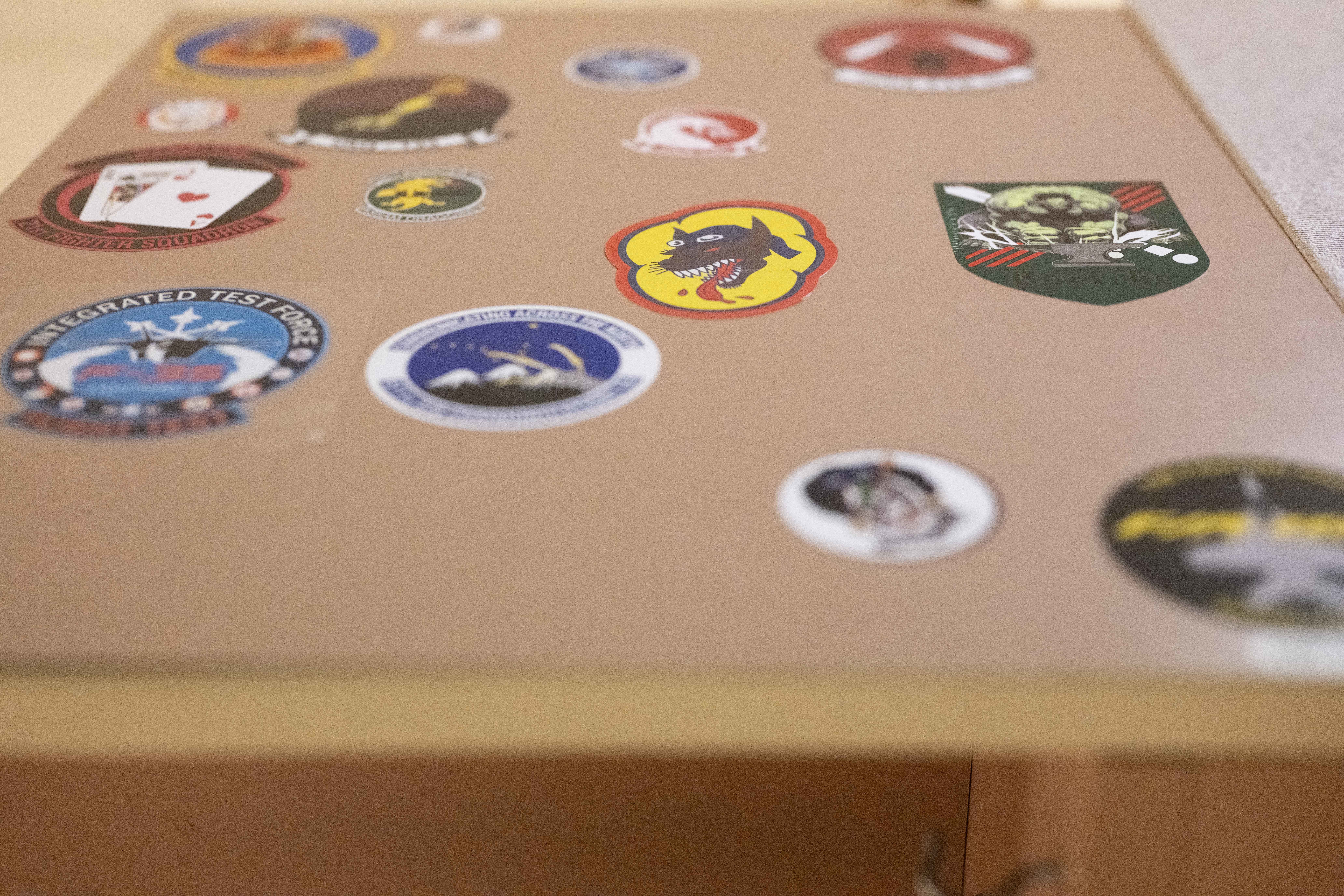 Stickers from units around the world who have supported Cope Thunder and Red Flag over the past 50 years lay on the walls of the Aircrew Flight Equipment office at the 353rd Combat Training Squadron on Eielson Air Force Base, Alaska, June 16, 2025. The collection reflects the legacy of units that have strengthened interoperability through Cope Thunder and Red Flag. (U.S. Air Force photo by Staff Sgt. Daniel Brosam)