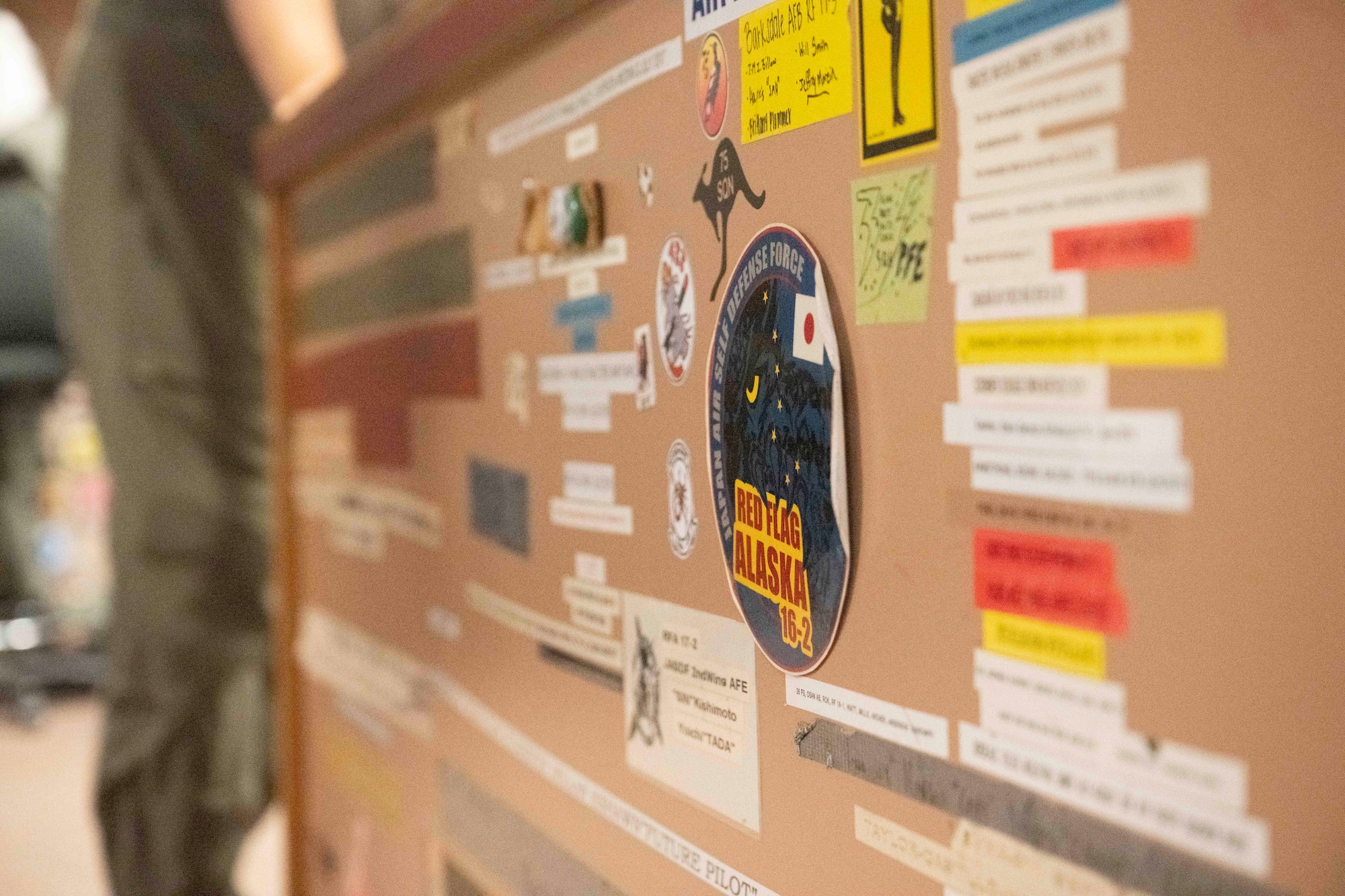 Stickers from units around the world who have supported Cope Thunder and Red Flag over the past 50 years lay on the walls of the Aircrew Flight Equipment office at the 353rd Combat Training Squadron on Eielson Air Force Base, Alaska, June 16, 2025.
