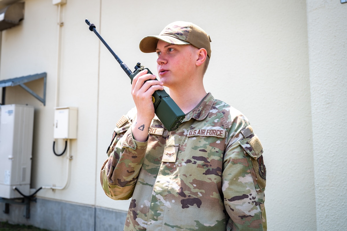 Wild Weasel of the Week, U.S. Air Force Airman Quintin Humbert, 35th Operations Support Squadron radar, airfield and weather systems technician, speaks over a handheld radio at Misawa Air Base, Japan