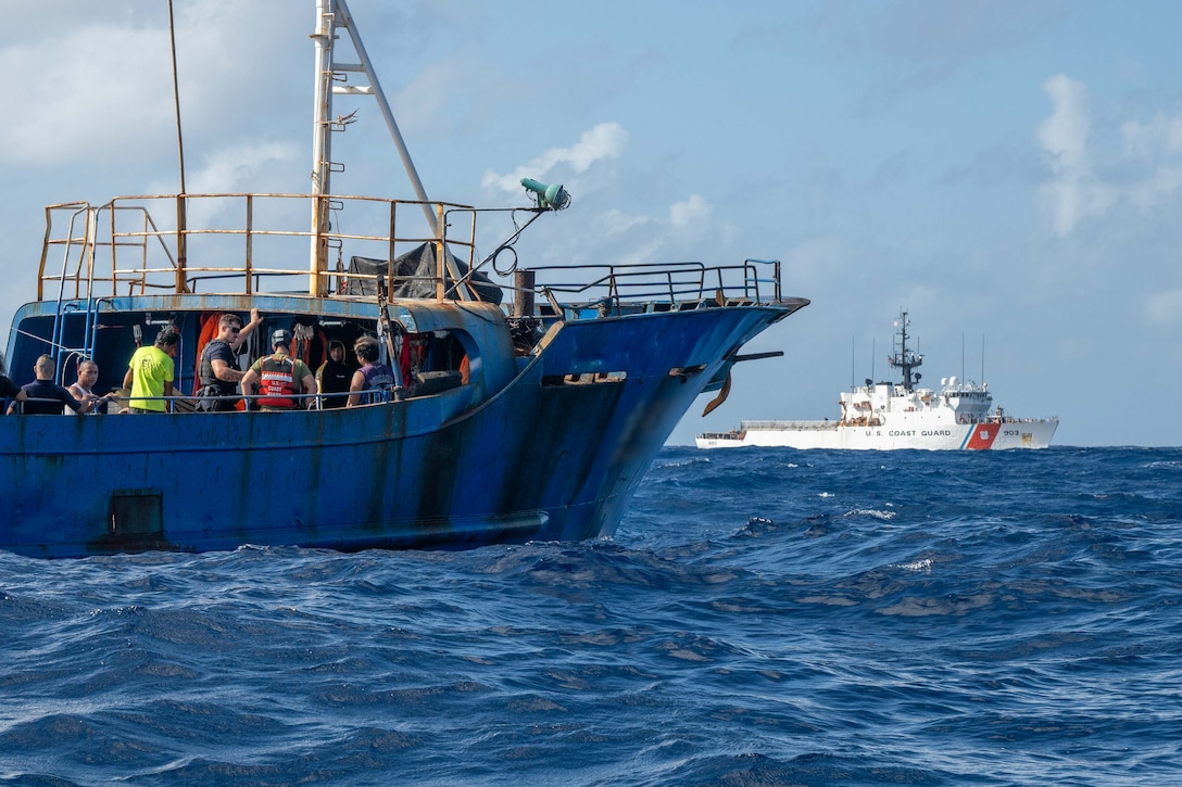 Crew members from U.S. Coast Guard Cutter Harriet Lane (WMEC 903) and Fishery Officers from the Cook Island Ministry of Marine Resources converse with crew members of a fishing vessel during an fishery inspection of the vessel June 7, 2025 in the Pacific Ocean. Harriet Lane’s presence in the Central Pacific region reinforces security and stability throughout Oceania. (U.S. Coast Guard photo by Petty Officer 3rd Class Austin Wiley)