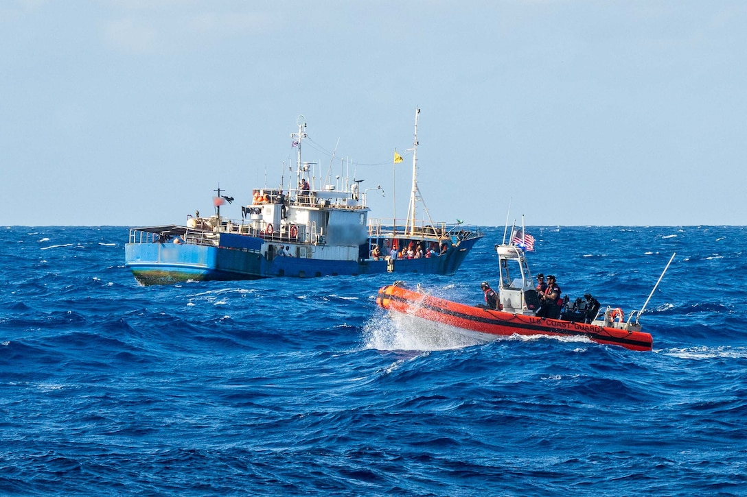 A 26-foot over-the-horizon small boat from U.S. Coast Guard Cutter Harriet Lane (WMEC 903) wades in the foreground as Fishery Officers from the Cook Island Ministry of Marine Resources perform bilateral maritime law enforcement operations June 7, 2025 in the Pacific Ocean. The U.S. Coast Guard and Cook Islands’ law enforcement agencies will detect, deter, and suppress illicit transnational maritime activity including maritime drug trafficking, illegal migration, and fisheries offences. (U.S. Coast Guard photo by Petty Officer 3rd Class Austin Wiley)