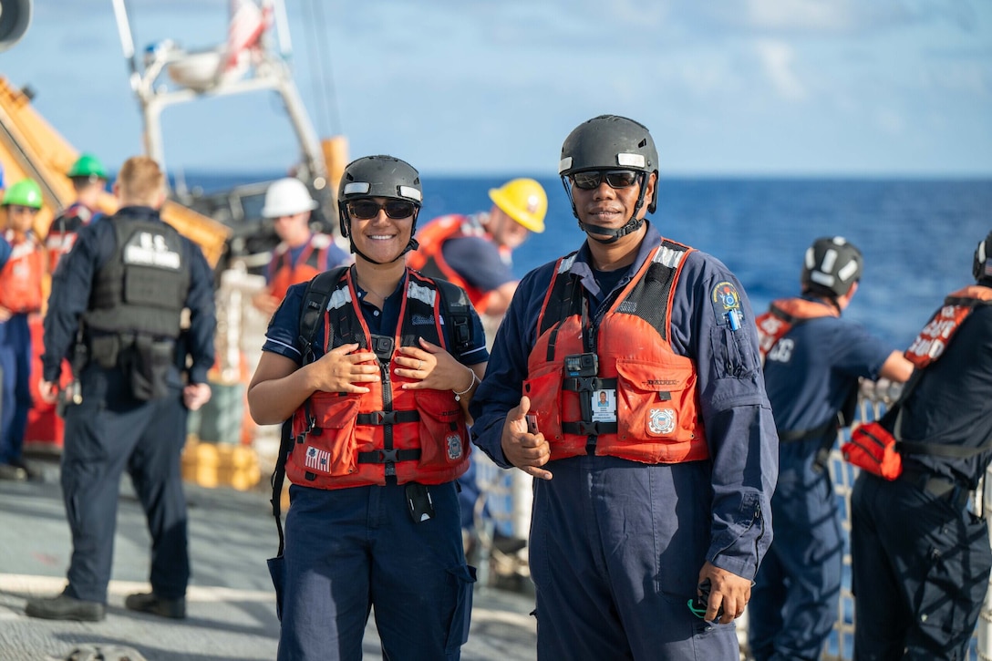 Cook Island Ministry of Marine Resources Officers Bermy Ariihee and Sai Sarau stand on the deck of U.S. Coast Guard Cutter Harriet Lane (WMEC 903) before performing bilateral fishery inspections and law enforcement operations within the Cook Islands Exclusive Economic Zone June 9, 2025. The U.S. Coast Guard and Cook Islands have a shared interest in enhancing maritime security through a bilateral maritime law enforcement “shiprider” agreement. (U.S. Coast Guard photo by Petty Officer 3rd Class Austin Wiley)