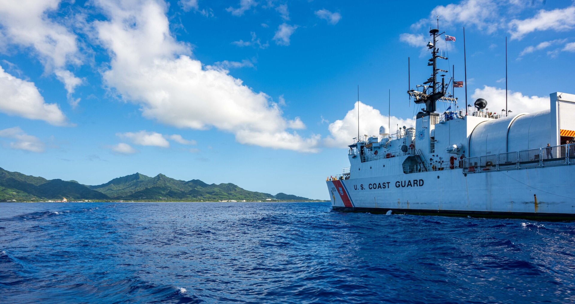 U.S. Coast Guard Cutter Harriet Lane (WMEC 903) approaches the island of Rarotonga in the Cook Islands during a passenger transfer and ship resupply on June 13, 2025. Harriet Lane is deployed to Oceania to advance relationships with ally and partner nations to build a more stable, free, open and resilient region with unrestricted, lawful access to the maritime commons. (U.S. Coast Guard photo by Petty Officer 3rd Class Austin Wiley)