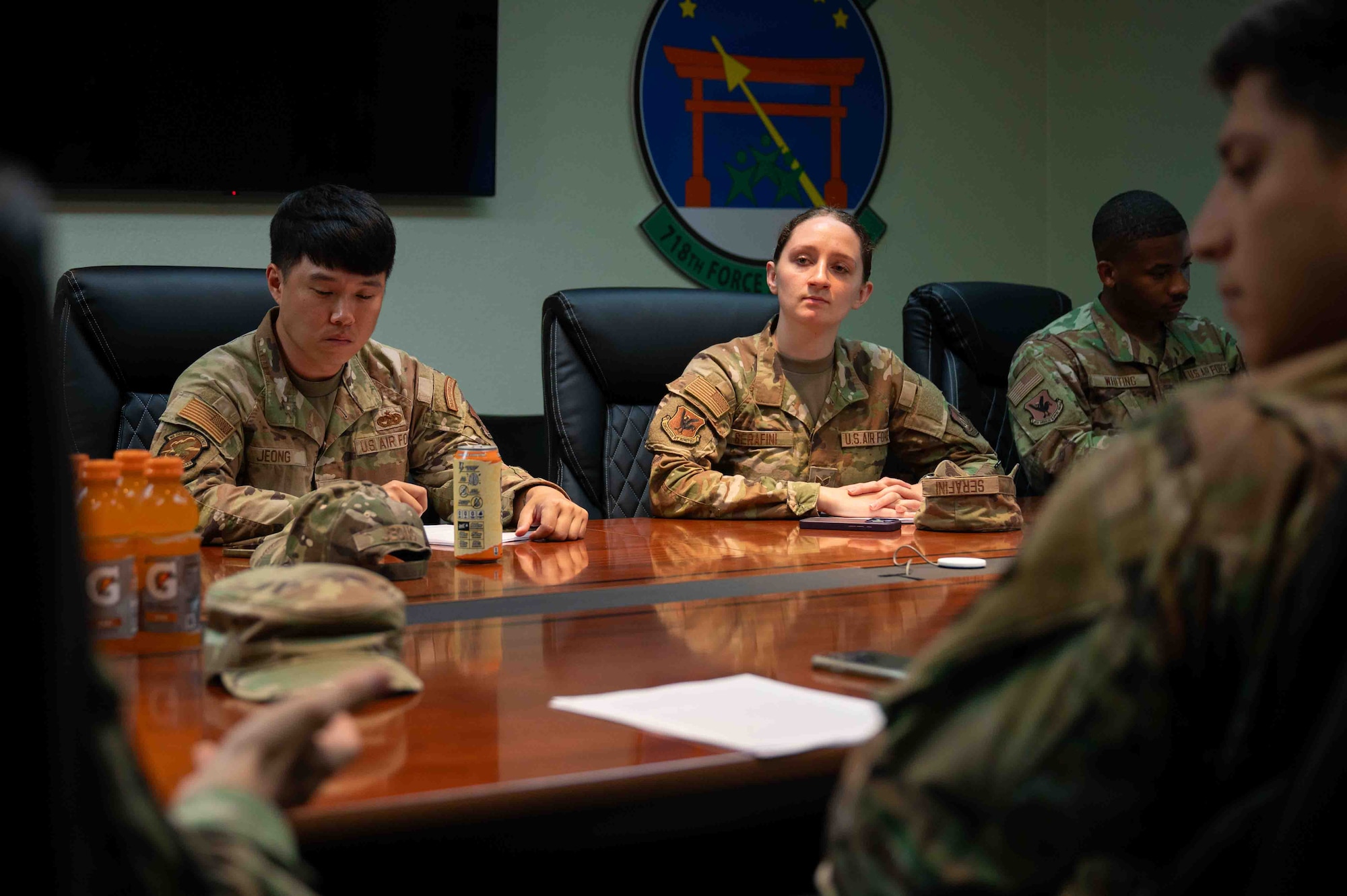 Service members sit at the table and have dialogue.