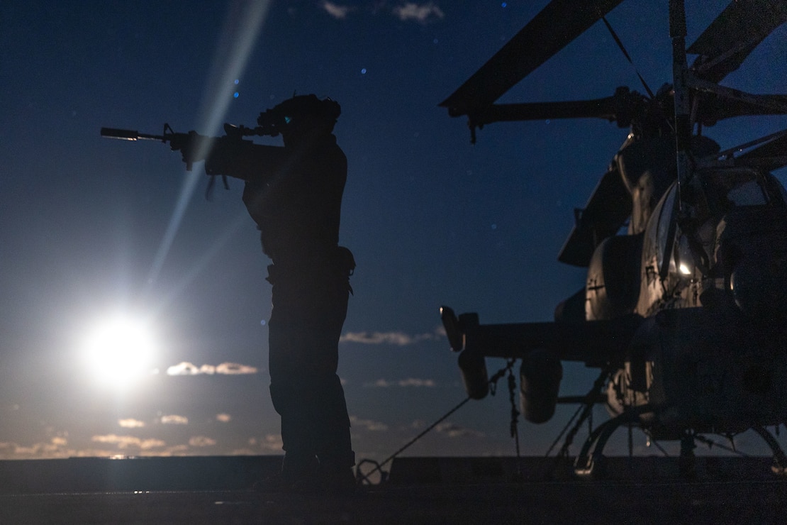 A U.S. Marine with Weapons Company, Battalion Landing Team 1st Battalion, 7th Marine Regiment, 31st Marine Expeditionary Unit, tests his L3Harris Binocular Night Vision Device (PVS-31) during a night live-fire deck shoot aboard amphibious transport dock USS San Diego (LPD 22), in the Timor Sea, June 12, 2025.