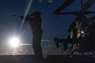 TIMOR SEA (June 12, 2025) — A U.S. Marine with Weapons Company, Battalion Landing Team 1st Battalion, 7th Marine Regiment, 31st Marine Expeditionary Unit, tests his L3Harris Binocular Night Vision Device (PVS-31) during a night live-fire deck shoot...