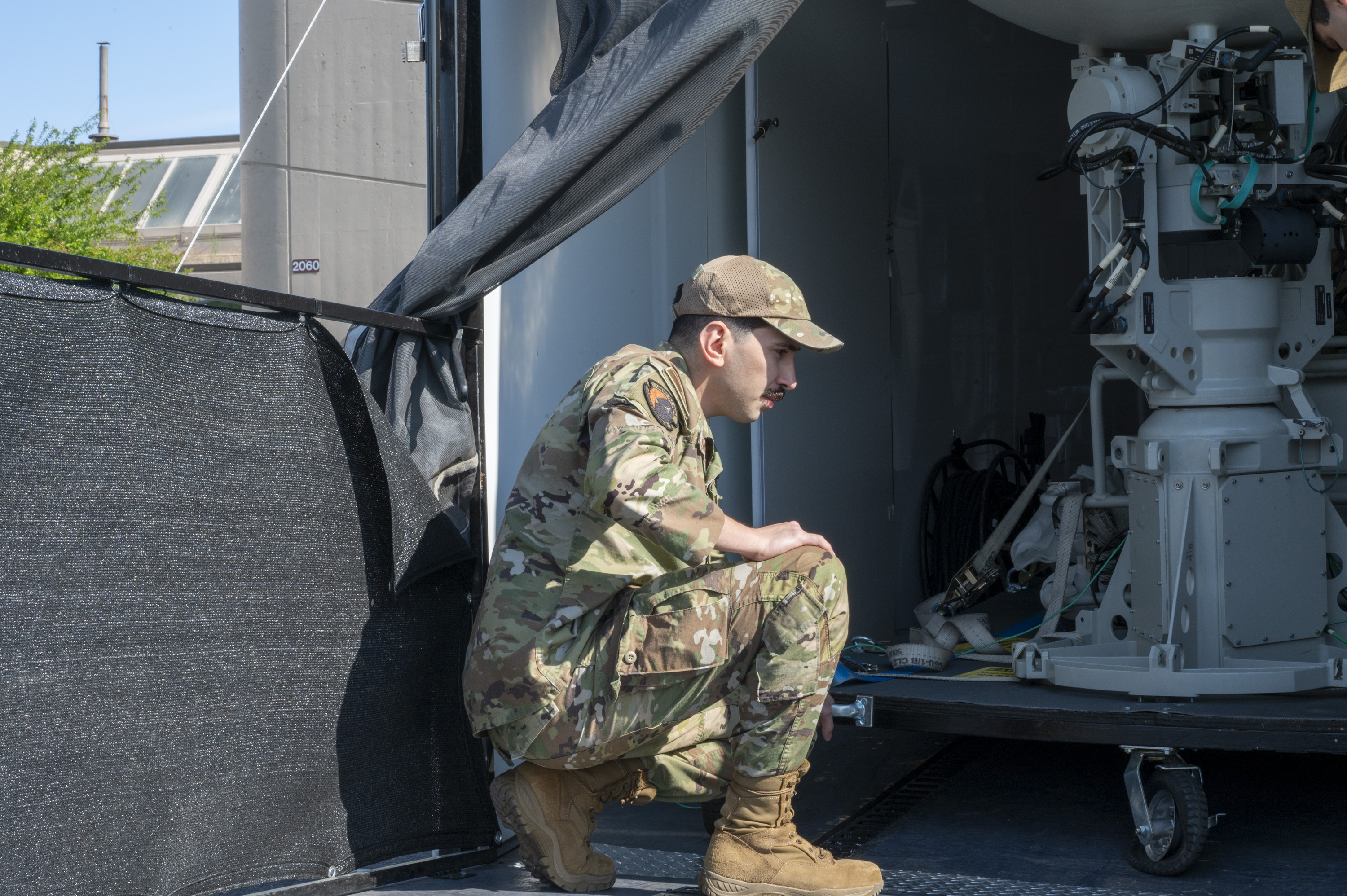 U.S. Air Force Staff Sgt. Joao Gabriel, 92nd Communications Squadron radio frequency operations noncommissioned officer in charge, inspects an antenna pedestal assembly at Fairchild Air Force Base, Washington, June 2, 2025.  The antenna pedestal assembly is a critical component of the Global Aircrew Strategic Network Terminal, which provides protected communication and supports aircrew in operational environments. (U.S. Air Force photo by Airman 1st Class Samantha Thorn)