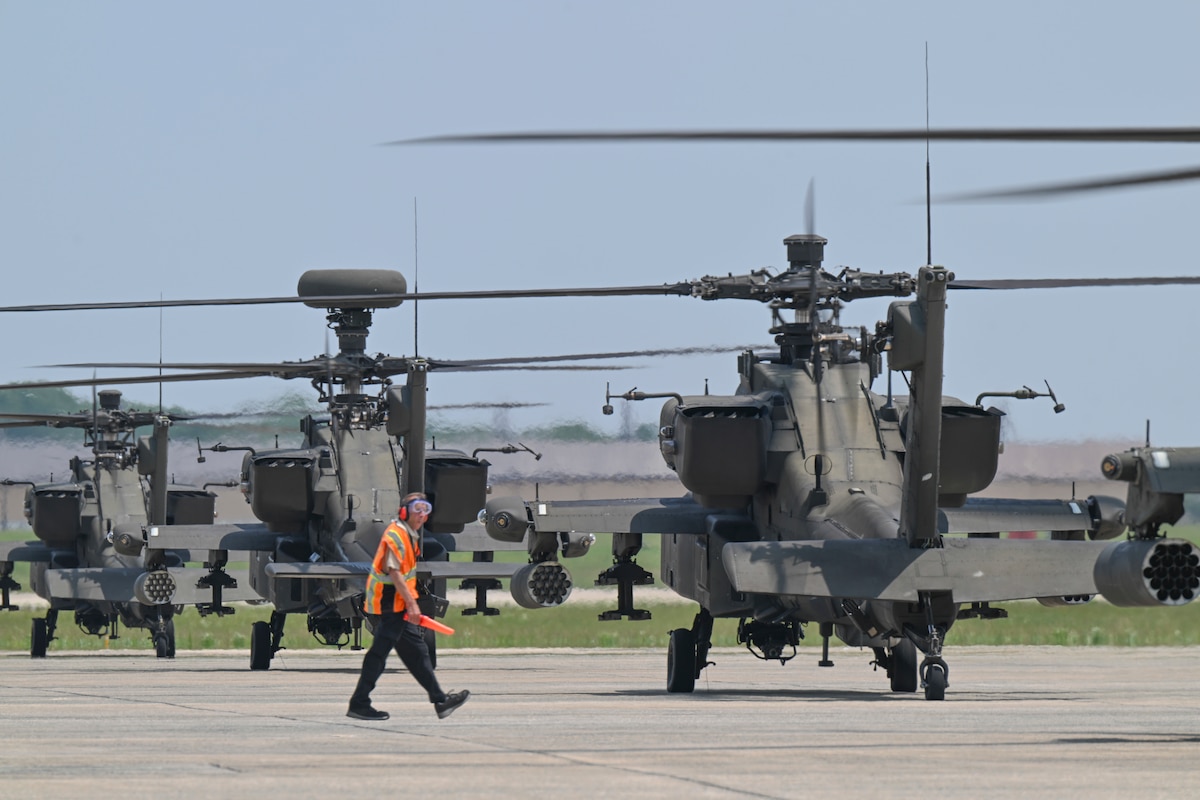 U.S. Army AH-64 Apache helicopters assigned to the 82nd Combat Aviation Brigade park on the flight line.