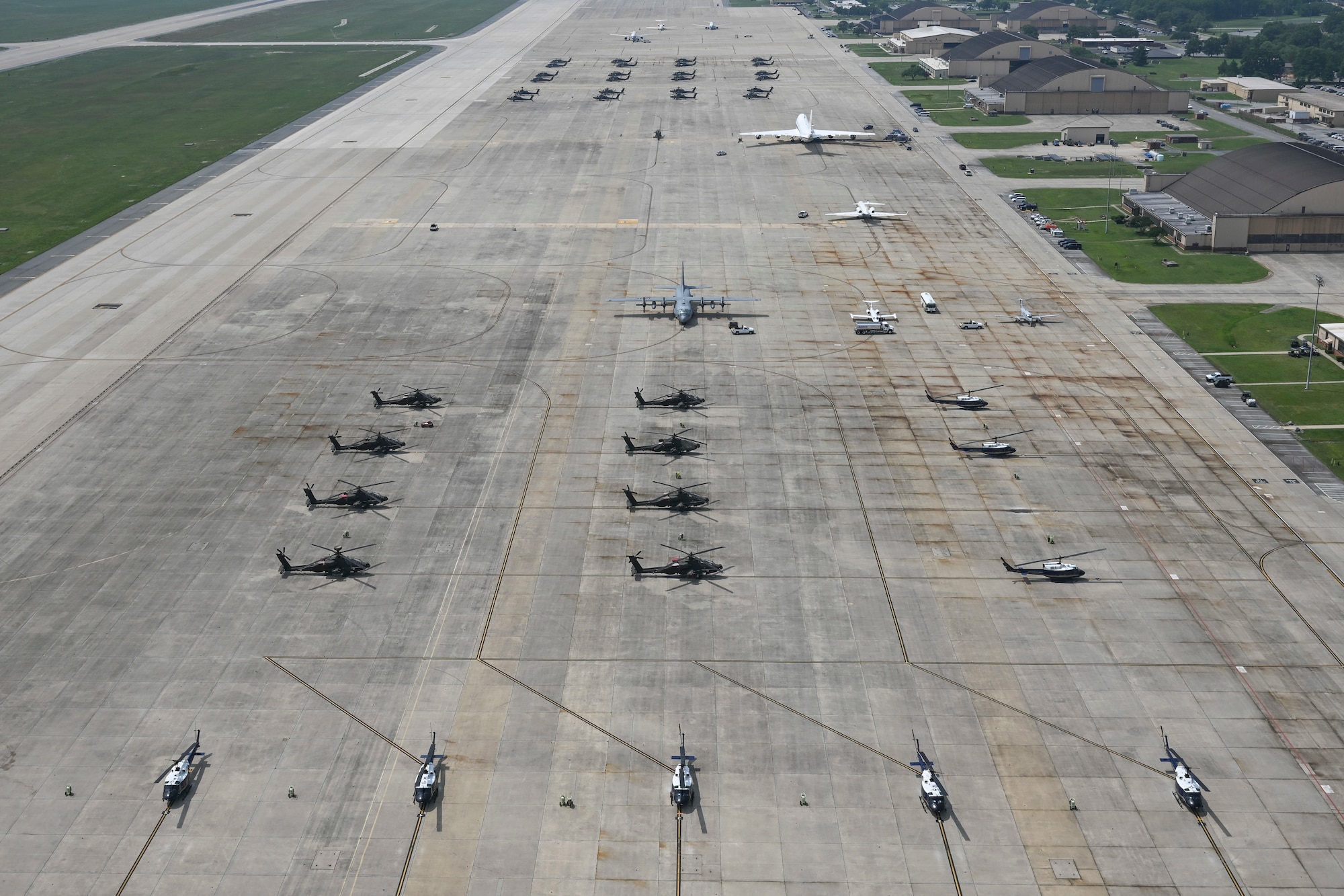 An aerial view shows U.S. Army and U.S. Air Force aircraft parked on the flight line.