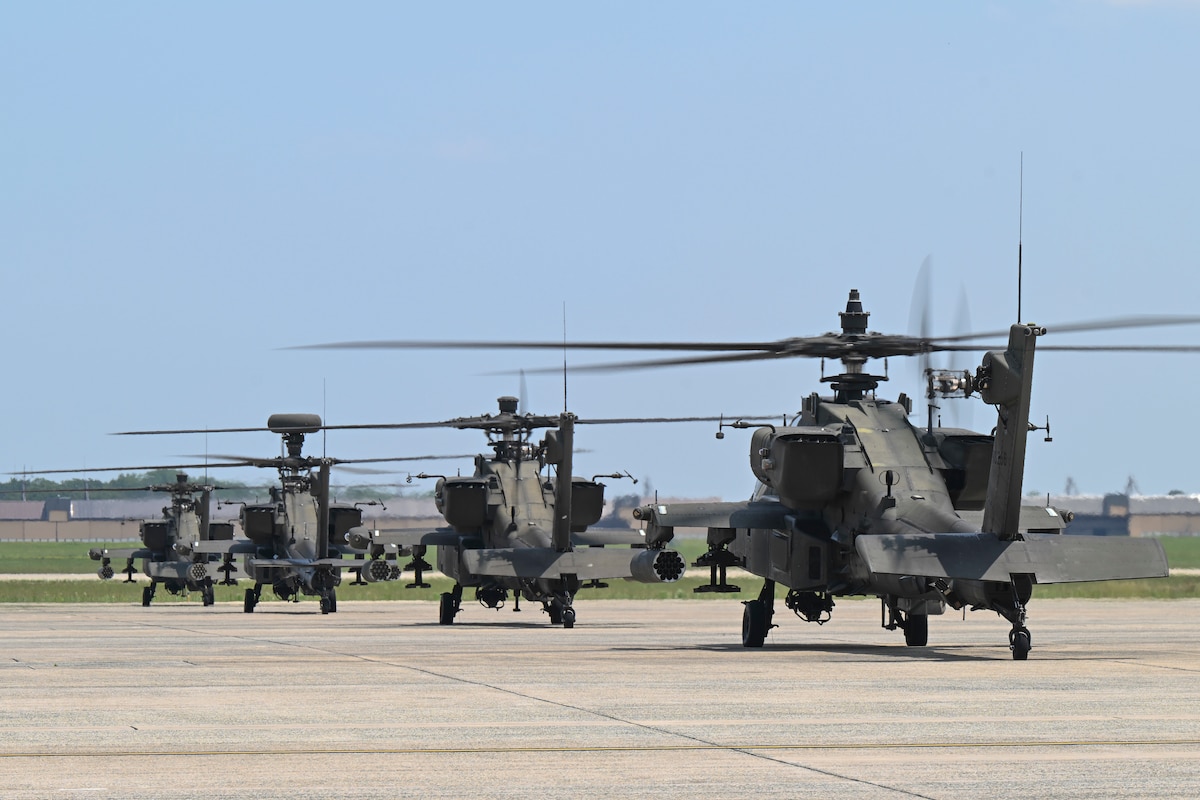 U.S. Army AH-64 Apache helicopters assigned to the 82nd Combat Aviation Brigade park on the flight line.