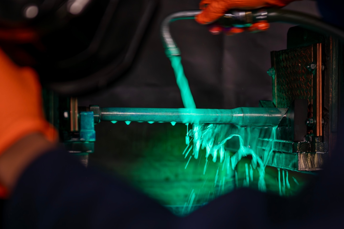 A U.S. Air Force 92nd Maintenance Squadron nondestructive inspection Airmen sprays magnetic particles on a copper bar at Fairchild Air Force Base, Washington, June 12, 2025. Magnetic particles acted as visual indicators of magnetic field leakage by accumulating at flaw locations on equipment, making them visible. (U.S. Air Force photo by Senior Airman Morgan St Marks)