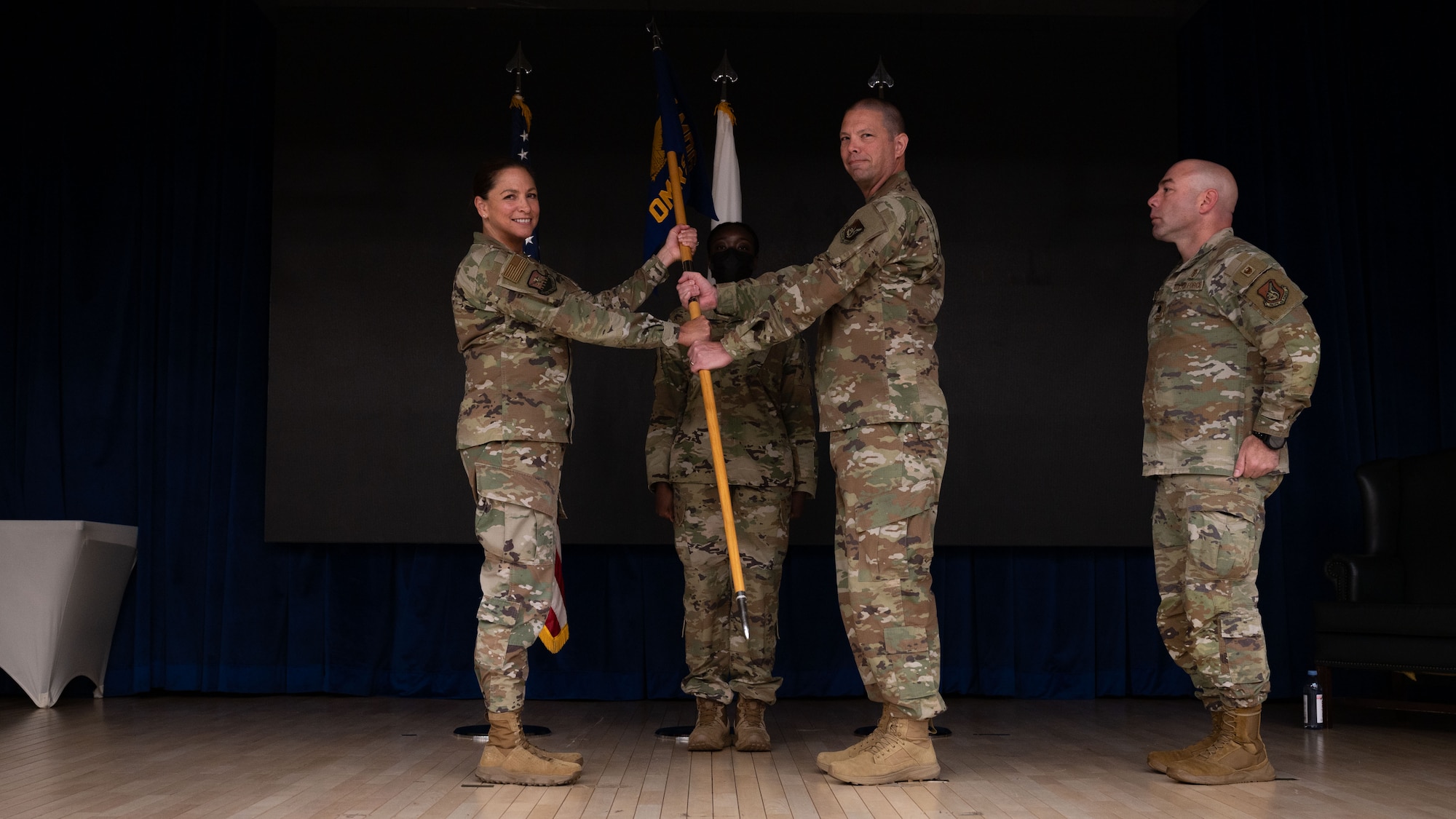 U.S. Air Force Col. Mocha Robinson, 51st Medical Group commander, receives the guidon from Col. Jamie Cornett, outgoing 51st Operational Medical Readiness Squadron commander, right, at Osan Air Base, Republic of Korea, June 17, 2025. Cornett provided leadership and guidance for 155 personnel in seven flights focused on maximizing the capability of the human weapon system. (U.S. Air Force photo by Senior Airman Rome Bowermaster)