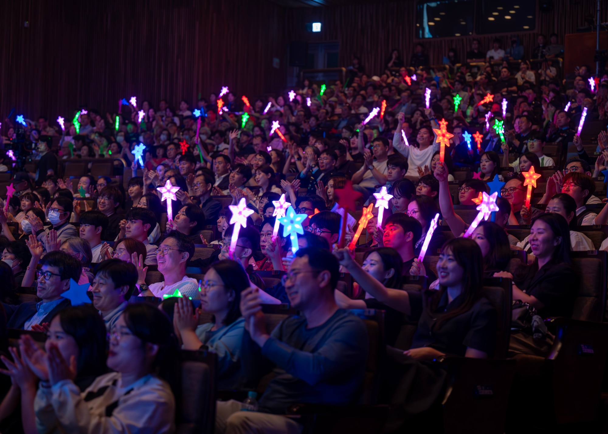 Audience members cheer during the annual Air Force Band Concert at the Korean Broadcasting System Hall in Seoul, Republic of Korea, June 12, 2025. The concert demonstrated the power of music to connect nations and reinforce international partnerships.  (U.S. Air Force photo by Staff Sgt. Sarah Williams)