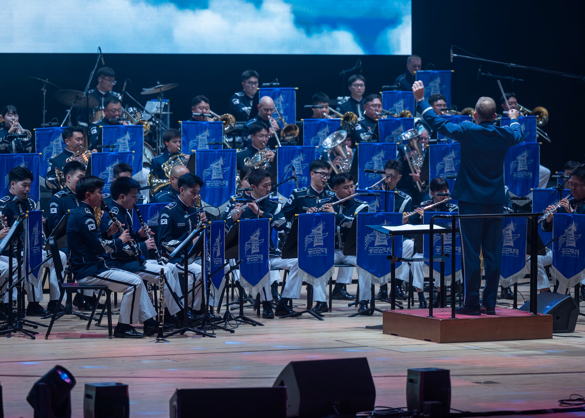 U.S. Air Force Lt. Col. Joseph Hansen, U.S. Air Force Band of the Pacific commander, conducts during the annual Air Force Band Concert at the Korean Broadcasting System Hall in Seoul, Republic of Korea, June 12, 2025. Hansen leads a 40-member ensemble that supports PACAF’s mission across the Indo-Pacific. (U.S. Air Force photo by Staff Sgt. Sarah Williams)