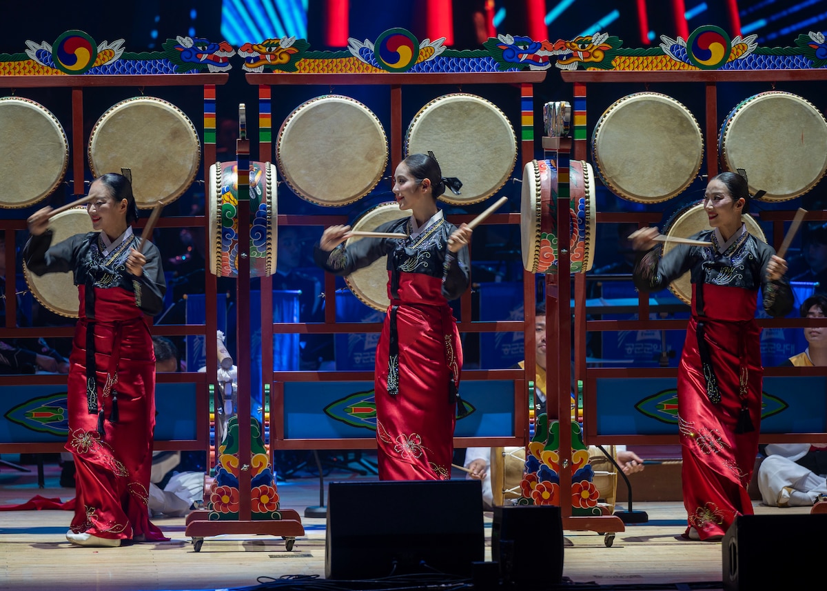 Ogomu performers showcase the traditional Korean drum routine during the annual Air Force Band Concert at the Korean Broadcasting System Hall in Seoul, Republic of Korea, June 12, 2025. Ogomu, the five-drum dance, showcased cultural heritage and added a dynamic element to the joint concert. (U.S. Air Force photo by Staff Sgt. Sarah Williams)
