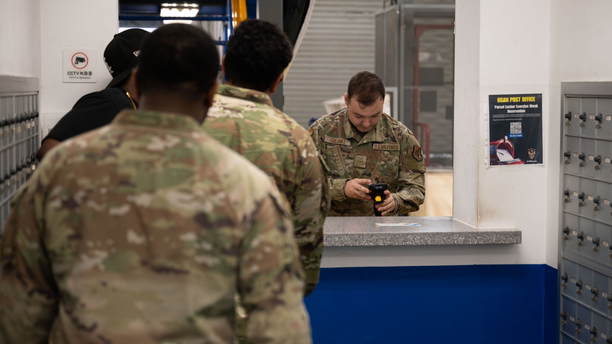 U.S. Air Force Airman 1st Class Andrew Greunke, 51st Force Support Squadron military postal clerk, assists customers with mail pickup at Osan Air Base, Republic of Korea, June 16, 2025. The Osan Military Post Office operates as an extension of the U.S. Postal Service to provide efficient and responsive services to authorized personnel and activities overseas during normal and contingency operations. (U.S. Air Force photo by Senior Airman Rome Bowermaster)