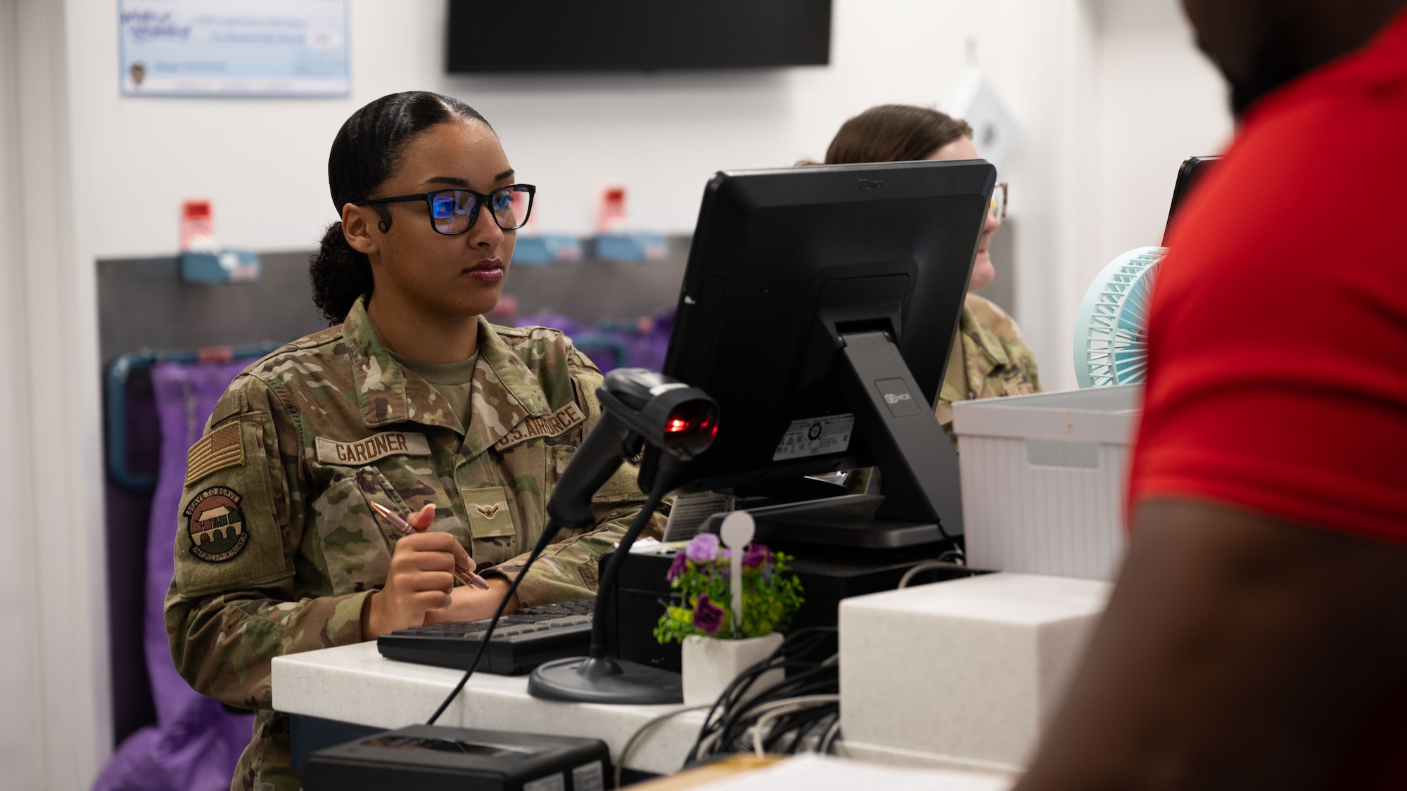 U.S. Air Force Airman Janai Gardner, 51st Force Support Squadron military postal clerk, reviews a customer’s shipping information at Osan Air Base, Republic of Korea, June 16, 2025. The Osan Post Office is responsible for delivering and receiving mail for service members, retirees, their families, and DoD civilians. (U.S. Air Force photo by Senior Airman Rome Bowermaster)